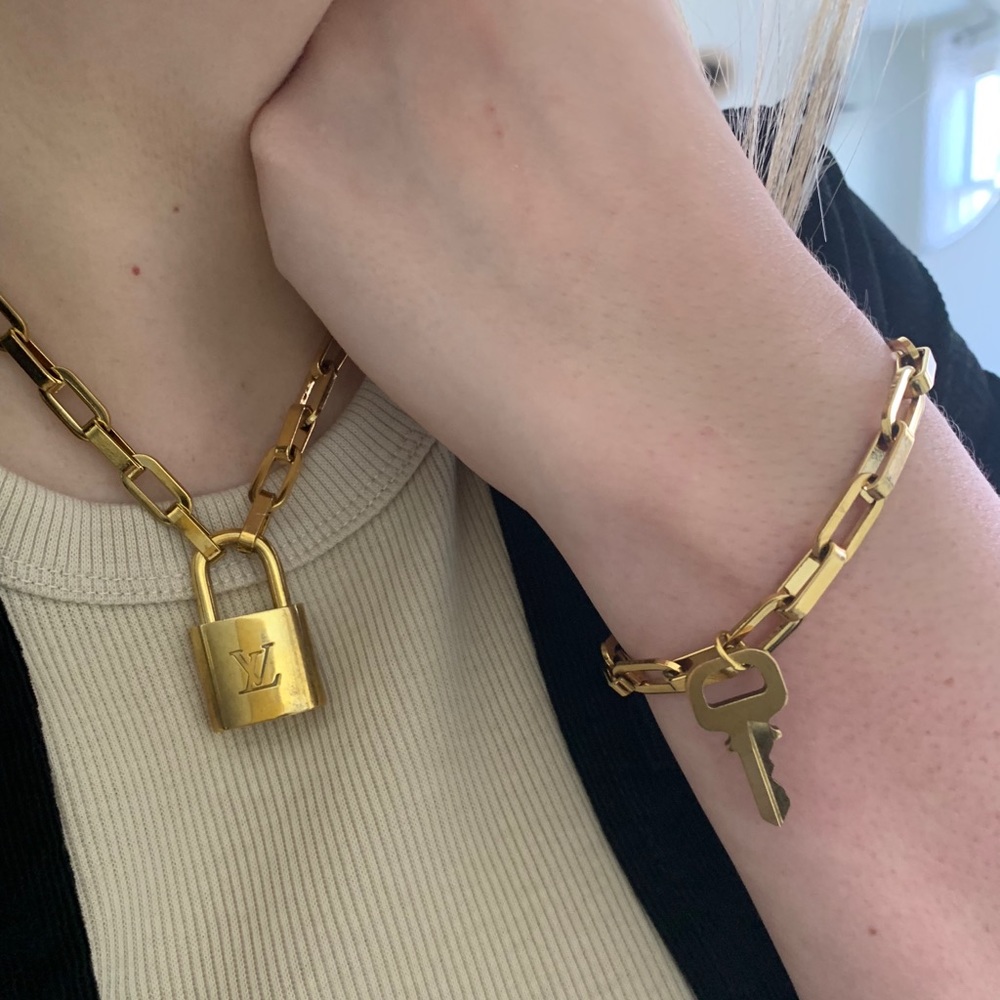 Authentic Louis Vuitton padlock and key on chain